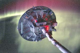 Ram side of the Wake Shield Facility (WSF) back dropped against the Southern Lights.